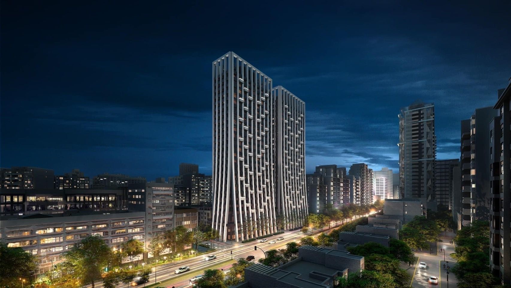 夜間的兩棟住宅塔樓，立面是一道道垂直的白色框架。